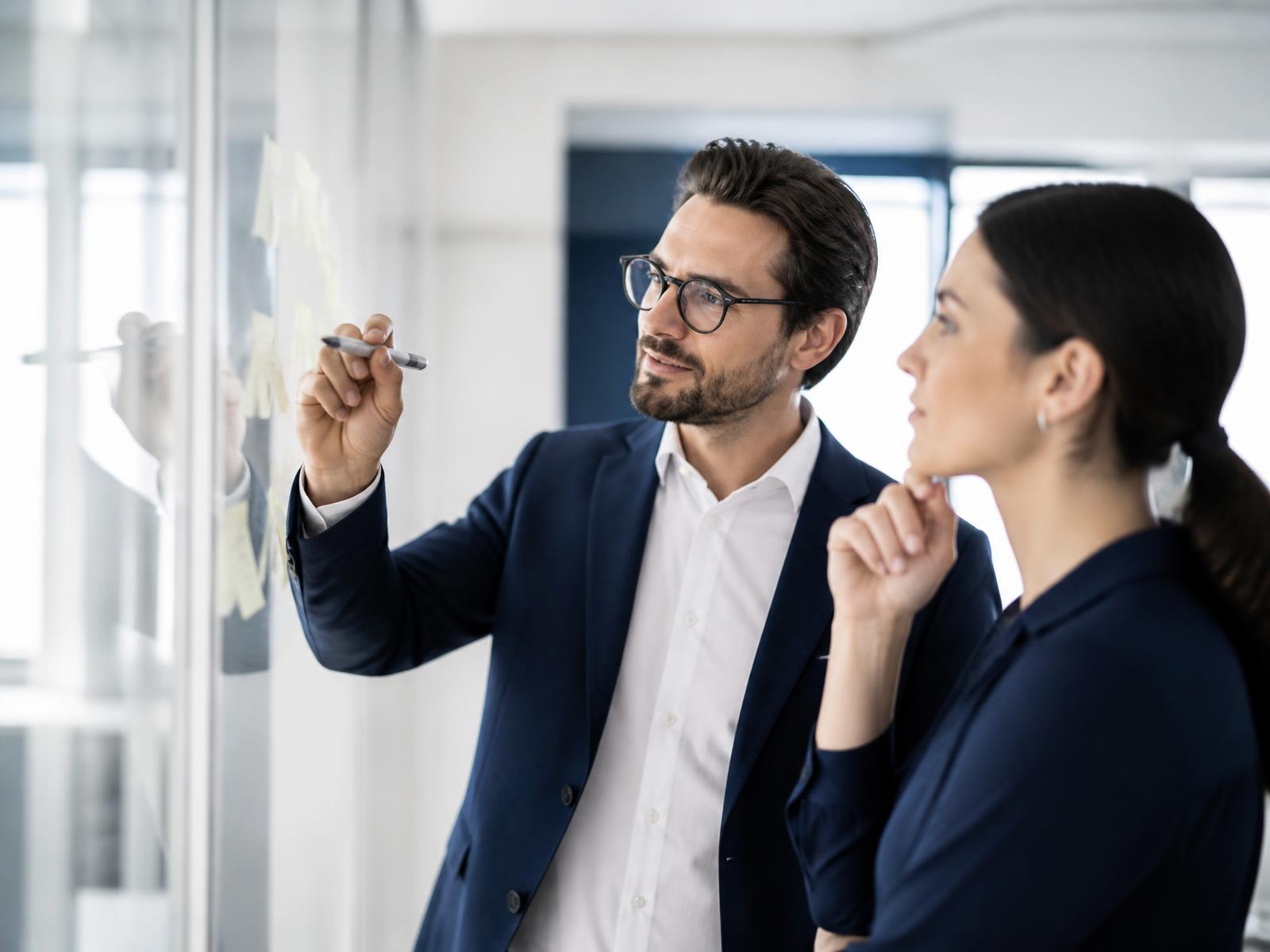 SEO Company in Ajmer — consultants mapping a campaign roadmap on a glass wall